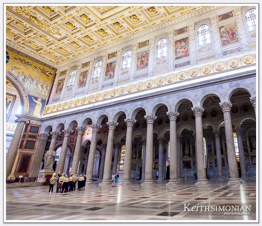 People in the photo give a sense of scale to the interior of Basilica Saint Paul Outside the Walls 