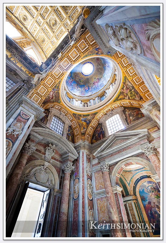 The light streaming through the dome highlights the beauty of the display on the ceiling - St. Peter's Basilica