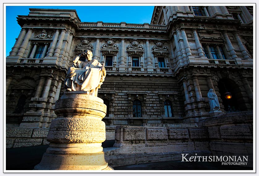 The early morning sunlight hits a statue outside the Palace of Justice in Rome Italy