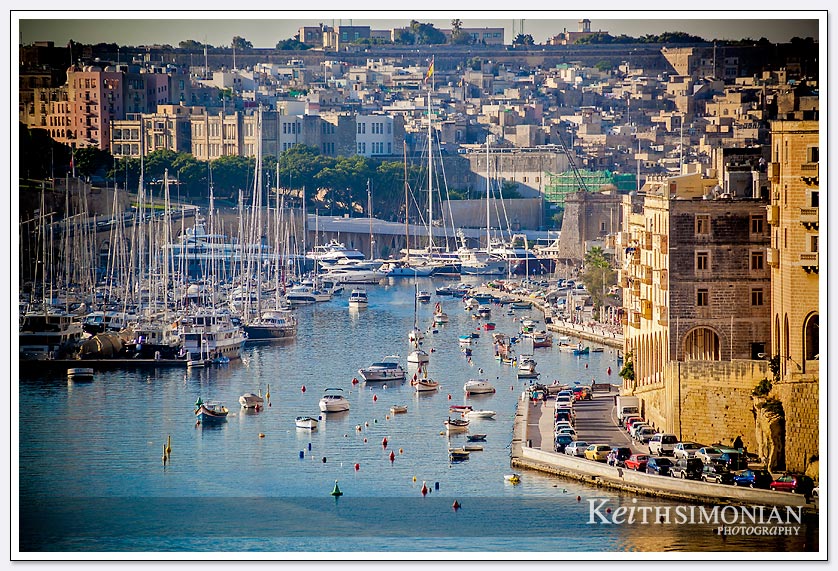 The early morning light hits the many boats in the port of Valletta, Malta