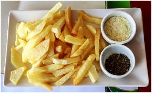 The local cuisine in Argostoli Greece included French Fries with condiments I didn't try.