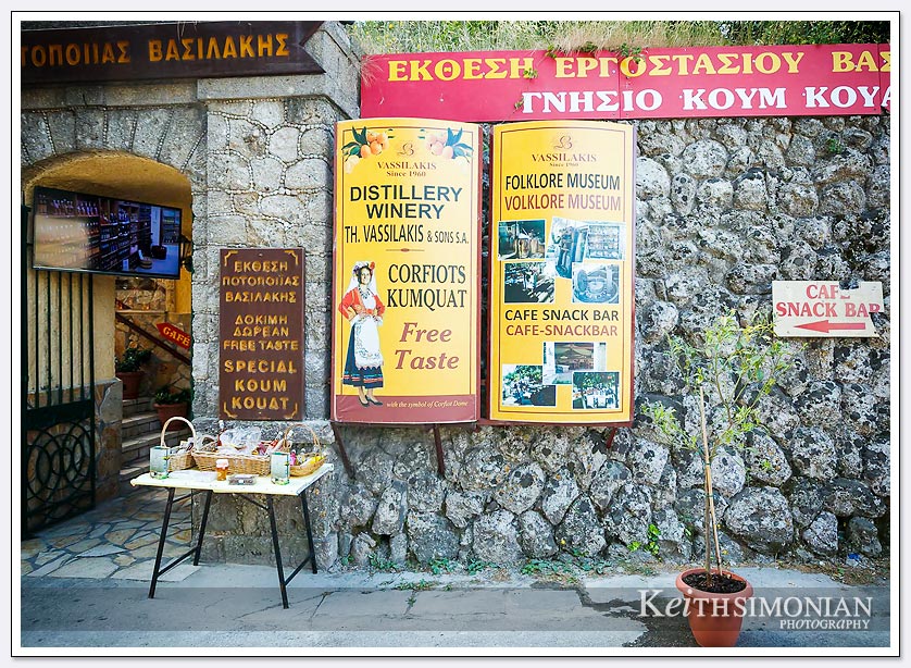 The sign on the wall offers a free taste of Corfiots Kumquat - Corfu, Greece
