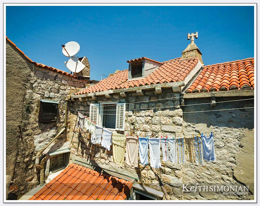 Laundry hangs outside one of the apartments that are inside the wall - Dubrovnik, Croatia