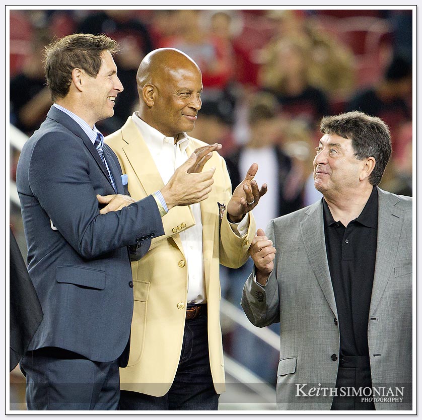 Steve Young, Ronnie Lott, and Eddie DeBartolo during a half time presentation to Charles Haley. 