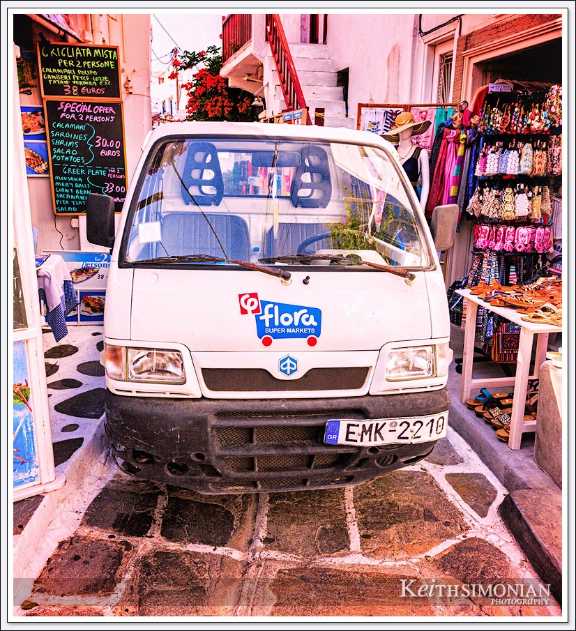The old town section of Mykonos Greece only has small pathways, so any delivery to the shops comes on very small delivery trucks.