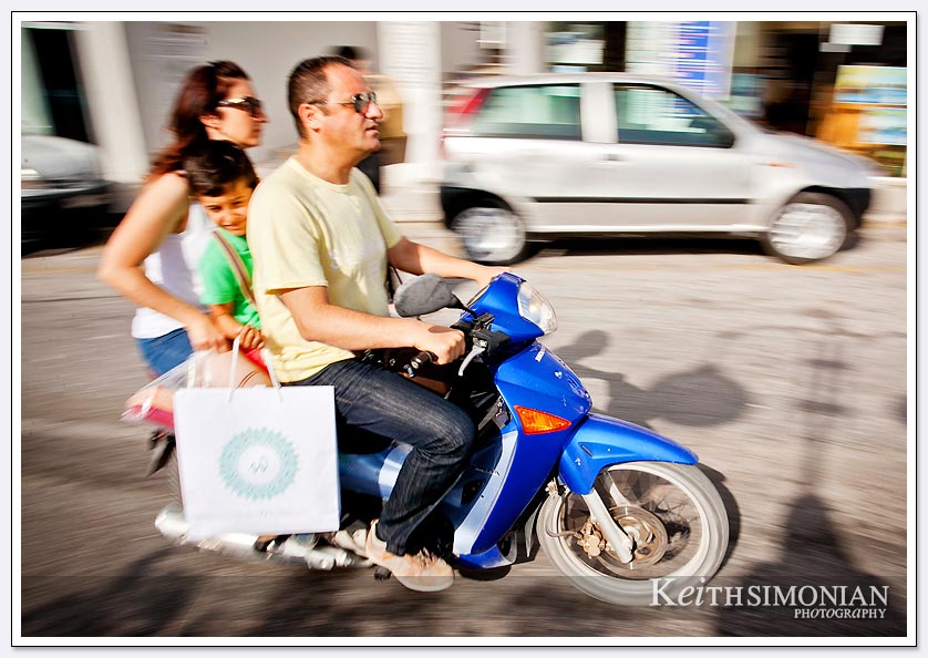 Family motorcycle ride on the island of Santorini, Greece