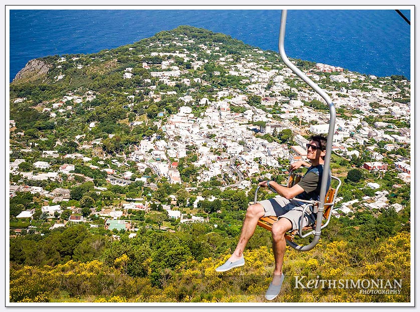 Single seat chair lift on Capri Island with views of the Mediterranean Ocean