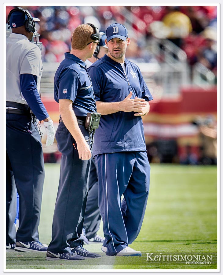 Quarterback Tony Romo stands alongside Dallas Cowboys head coach Jason Garrett