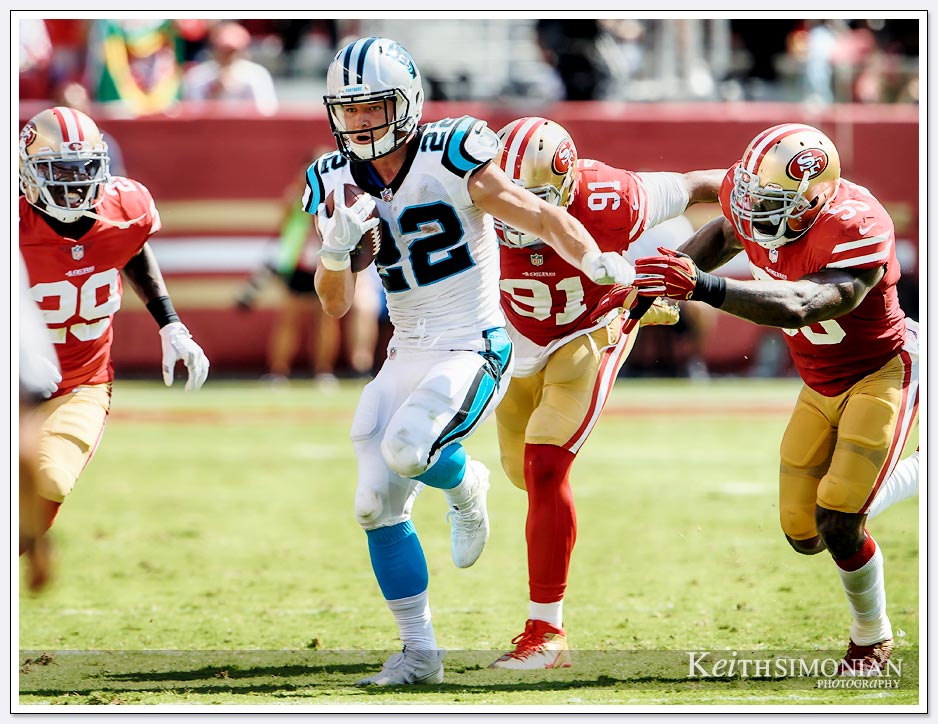 Carolina Panthers running back #22 Christian McCraffey eludes 49ers defends during the Panthers September 10, 2017 victory over the San Francisco 49ers at Levi's Stadium in Santa Clara. 
