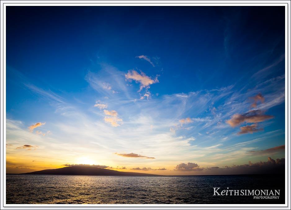 A sunset cruise with wonderful clouds that frame the island of Lanai Hawaii