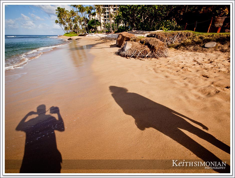 Walking along the Maui beach with the sun casting our shadows into the photo