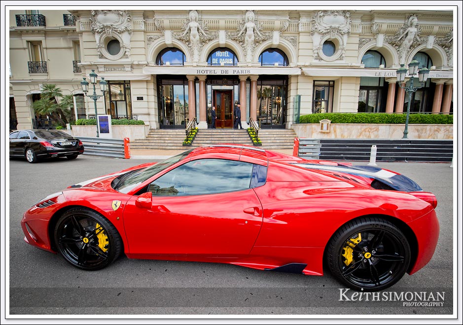 Red Ferrari parked in front of the Hotel de Paris in Monte Carlo. 