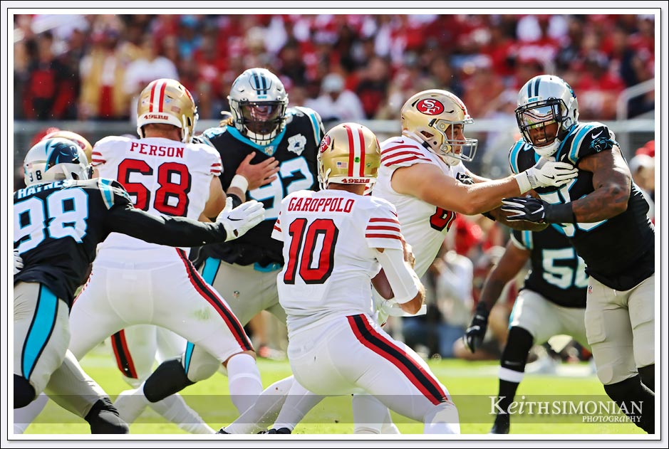 49ers quarterback Jimmy Garoppolo eludes several Carolina Panther rushers on this play. 