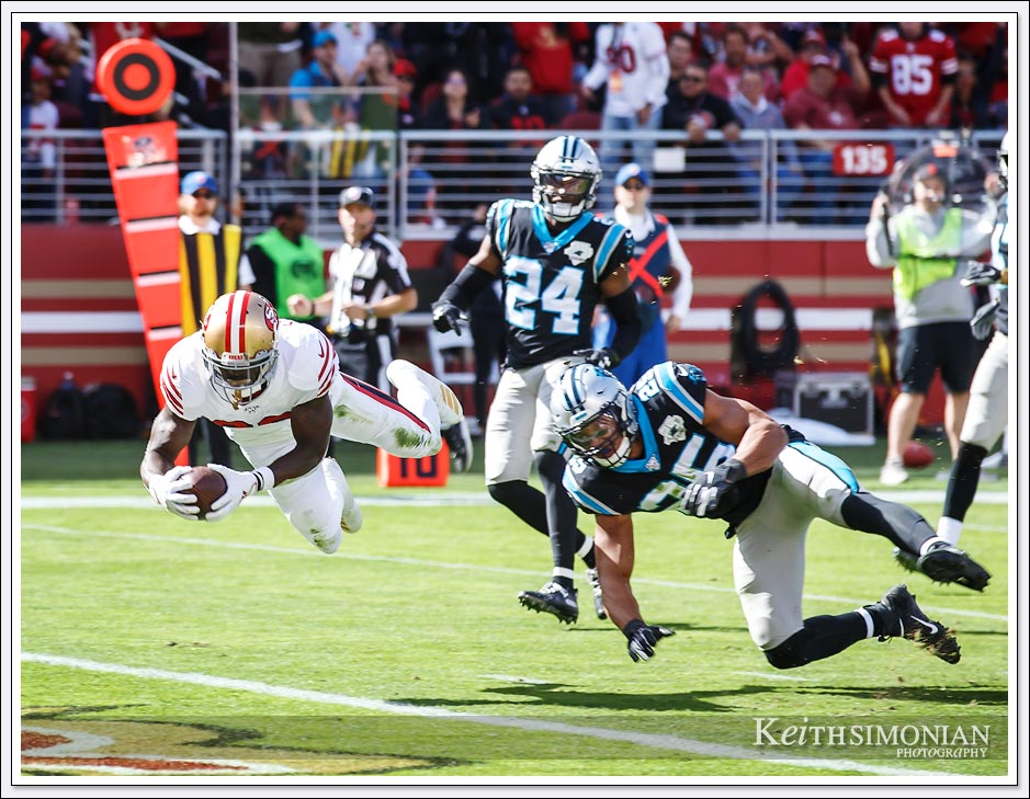 San Francisco 49er #26 Tevin Coleman scores one of his three touchdowns against the Carolina Panthers.