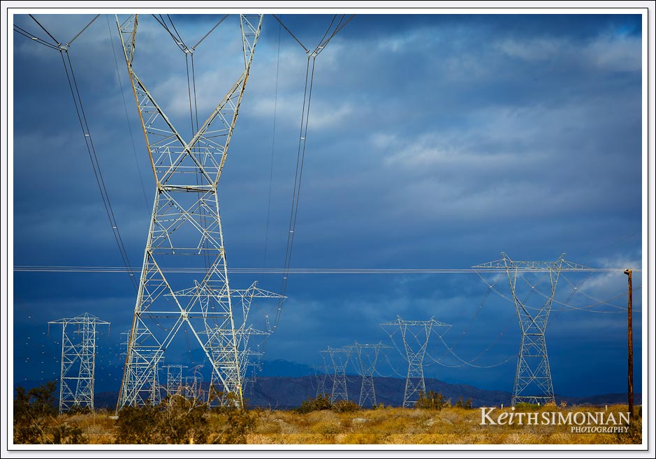 Dark clouds over electrical transmission lines in the California desert. 