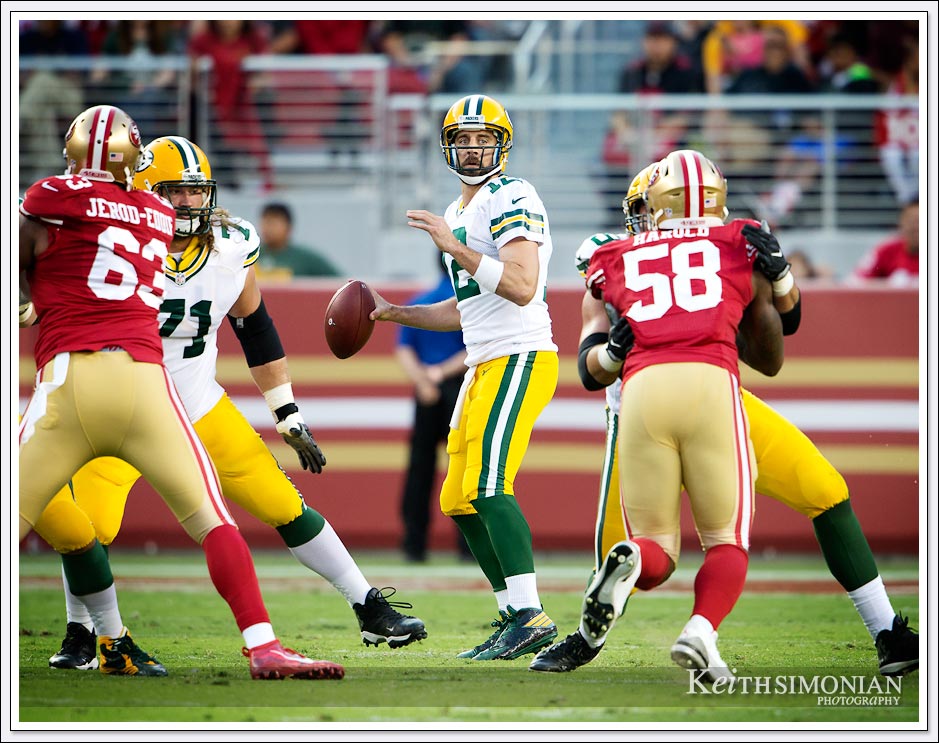 Green Bay Packer quarterback Aaron Rodgers looks for a receiver down field during a 2016 game against the San Francisco 49ers at Levi's stadium - Santa Clara, CA.