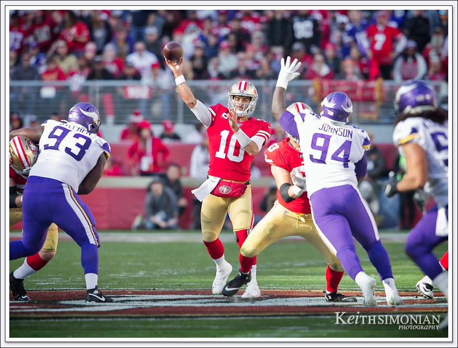 San Francisco 49er quarterback 10 Jimmy Garoppolo throws down field against the Minnesota Vikings.