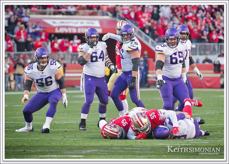 Five Minnesota Vikings offensive lineman watch as #99 DeForest Buckner and #55 Dee Ford sack quarterback Kirk Cousins in the Divisional playoff round on January 11th, 2020 at Levi's Stadium. 