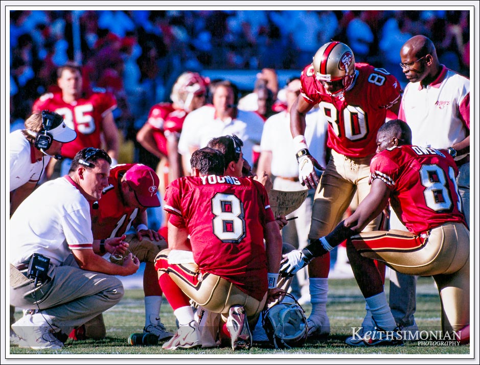 This discussion during time out to discuss the next play includes three San Francisco 49ers who will enter the NFL Hall of Fame. Steve Young, Jerry Rice, and Terrell Owens ( TO ).