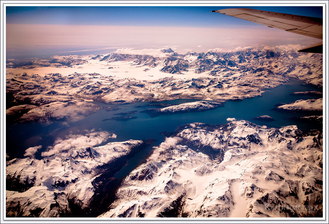 View from 39,000 on Flight from Seattle Washington to Fairbanks Alaska of snow covered mountains in the Glacier Bay National Park and Reserve in Alaska.