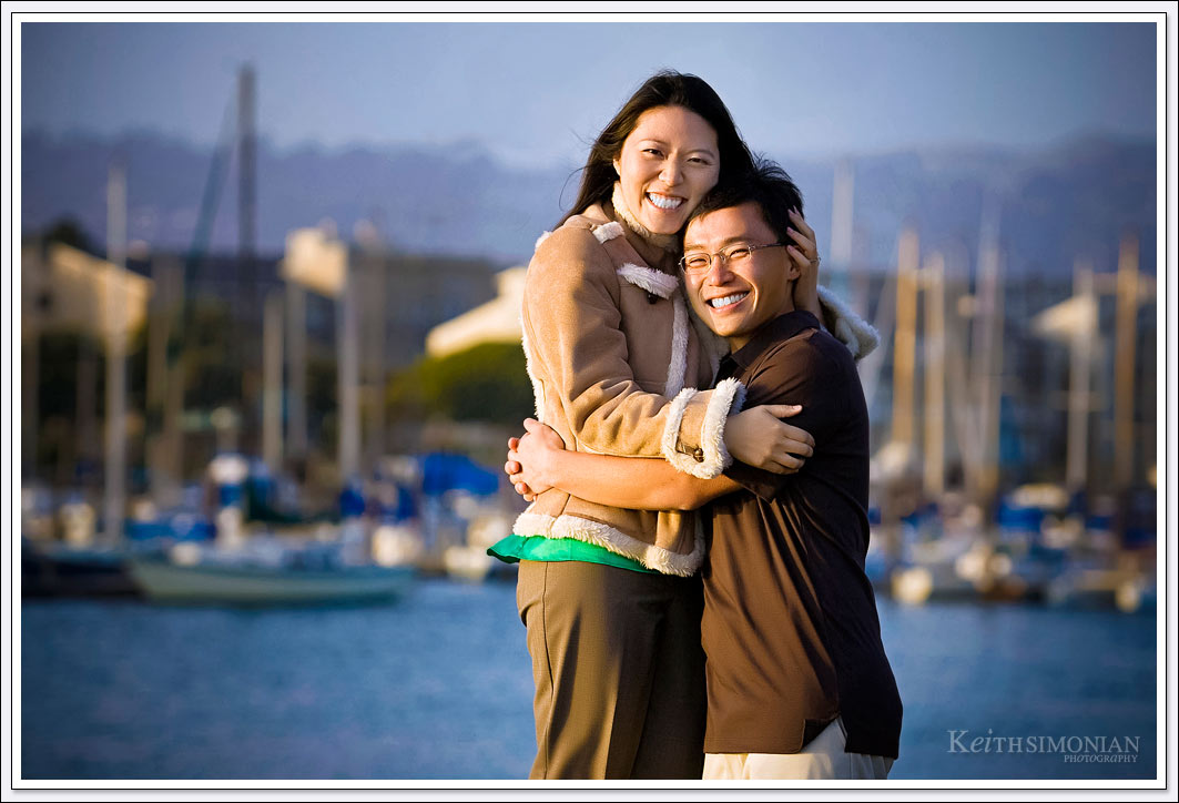 The many sail boats tied up at the Oakland Marina serve as splendid backdrop for Engagement photos in Oakland, California