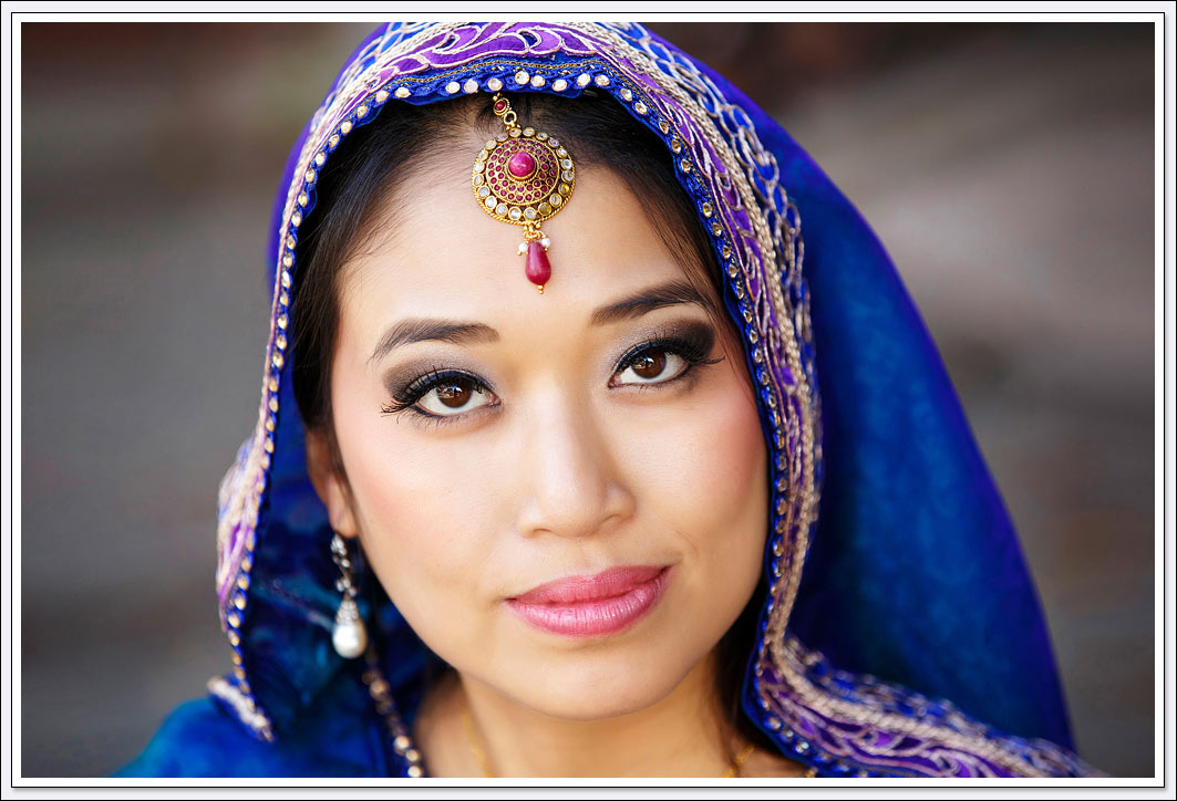 This South Asian bride is wearing a blue veil 