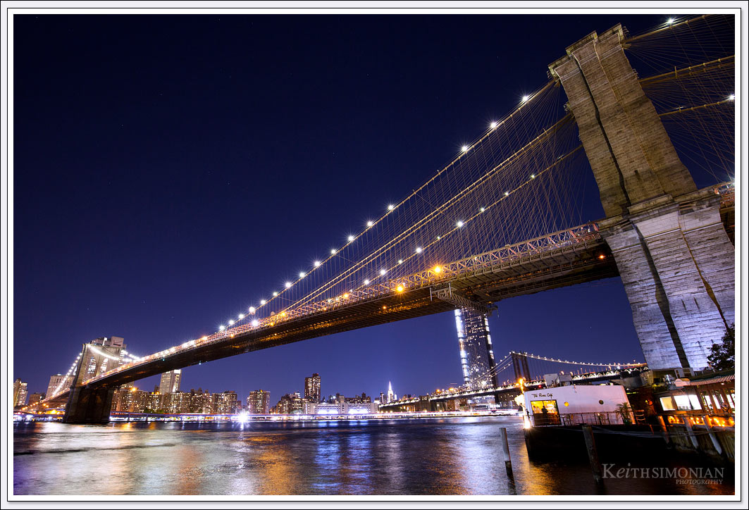 The nighttime reflections in the East River make this photo of the Brooklyn Bridge almost twinkle. 