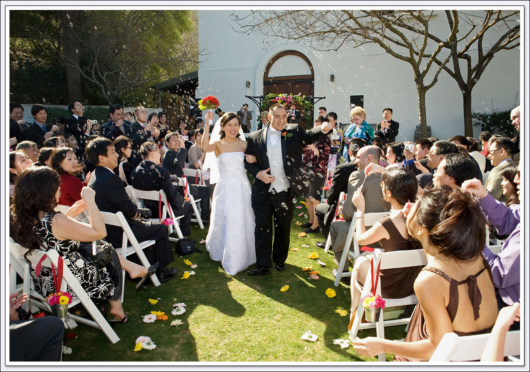 Bubbles greet the bride and groom as they walk down the aisle at Wente Vineyards