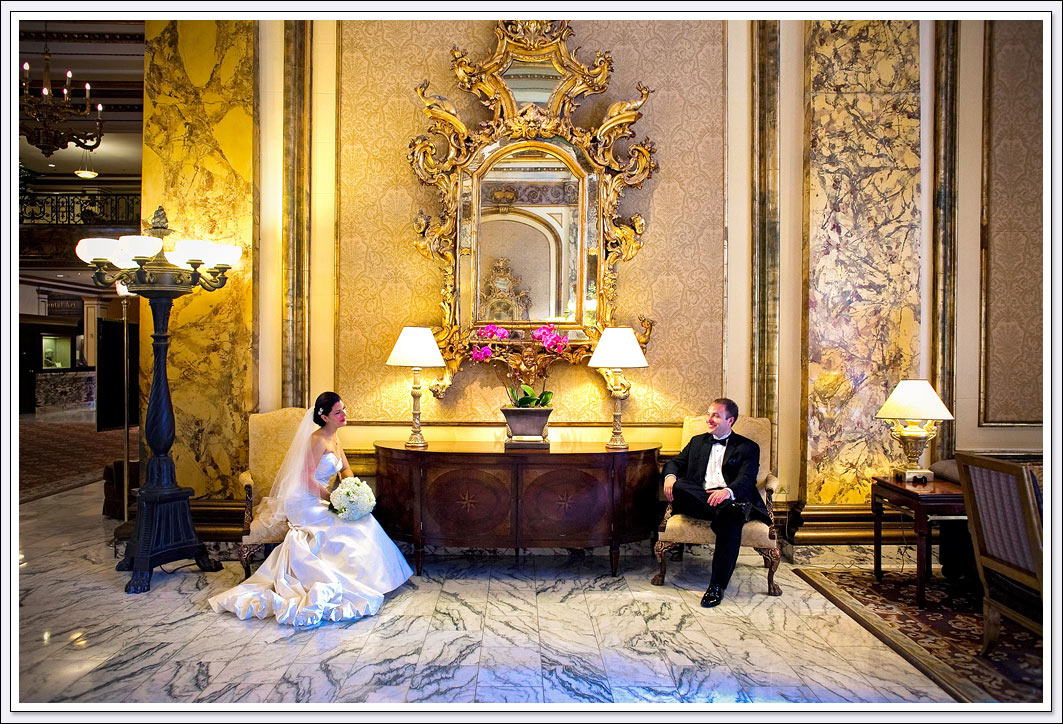 The world renowned Fairmont hotel lobby provides a stunning backdrop for wedding photos of the bride and groom in San Francisco, California.