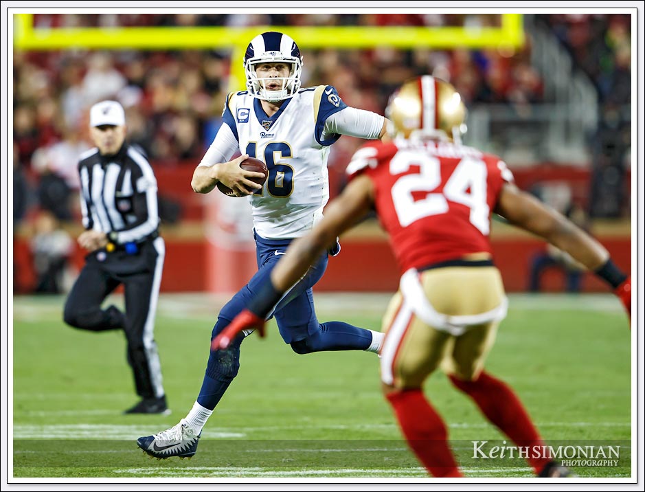 Los Angeles Rams Quarterback #16 Jared Goff eludes a San Francisco 49er defender