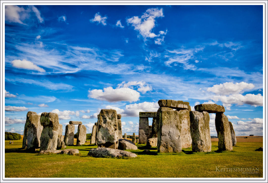 The rare sunny day with blue skies and nice white clouds over the famous prehistoric monument in Wiltshire, England that is Stonehenge. 