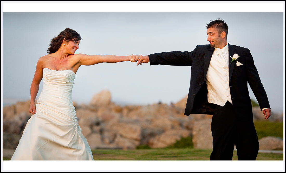 Pacific Ocean as backdrop the bride and groom hold hands - Lovers Point 630 Ocean View Blvd,  Pacific Grove, CA 93950