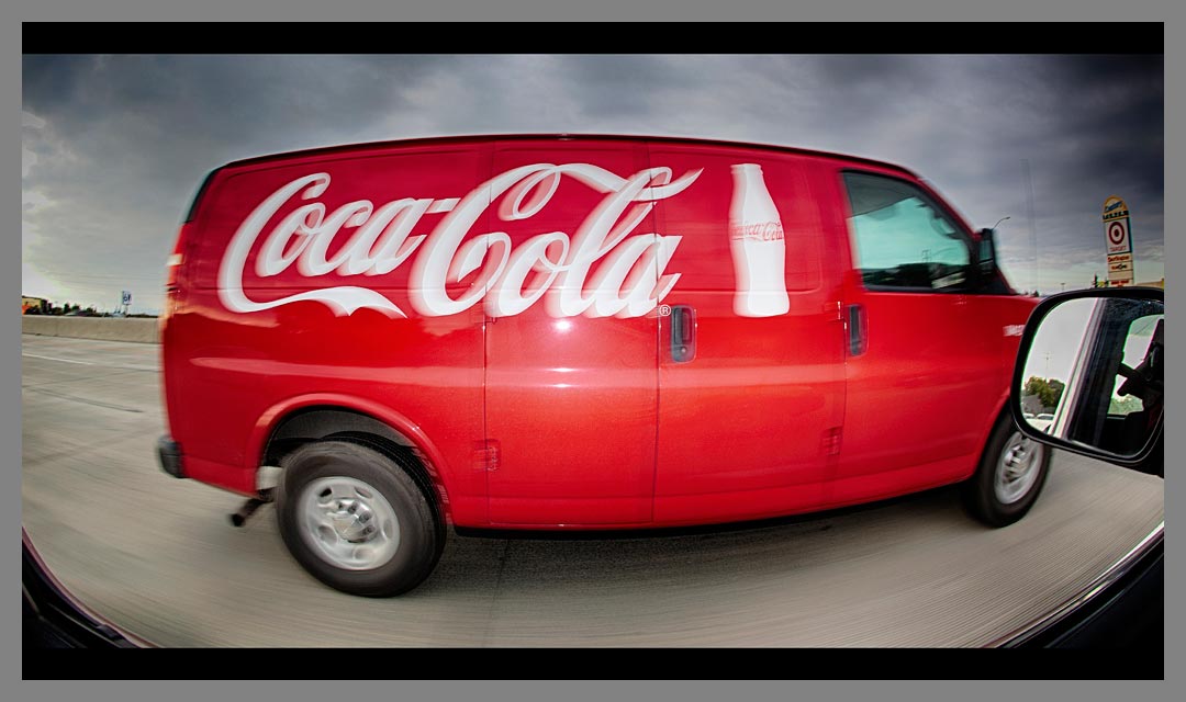 The fill flash on the Coca-Cola van makes the red color pop against the gray sky.