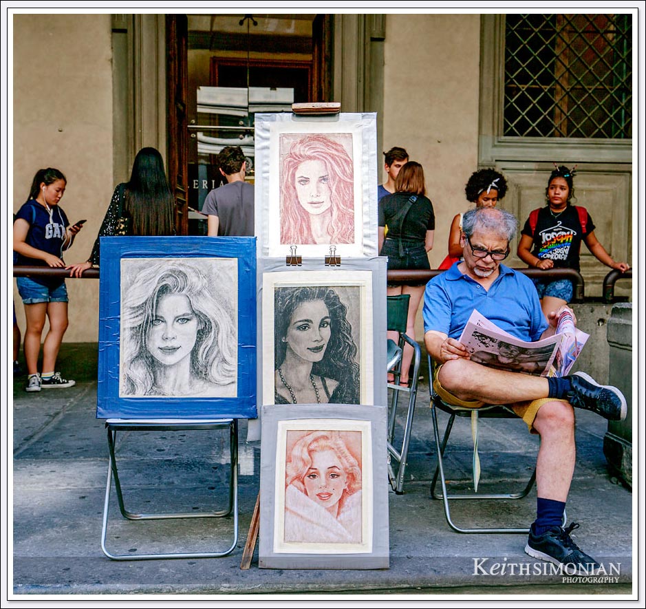 Florence Italy - local artist displays his work outside Uffizi gallery.