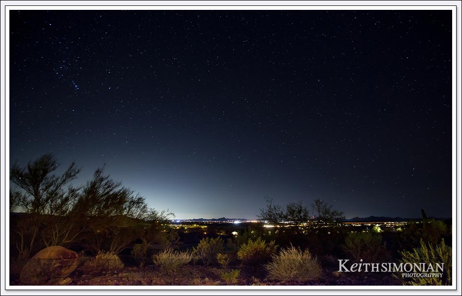 Stars over Wickenburg, Arizona with glow of lights from Phoenix, Arizona in the distance. 