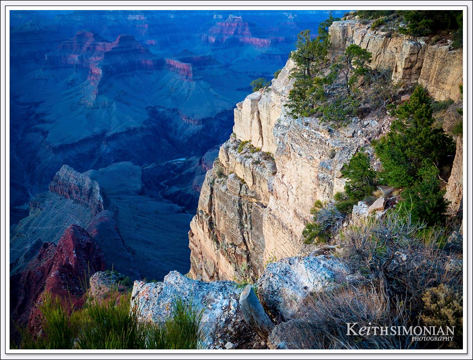The setting sun casts light on the South Rim of the Grand Canyon - Arizona.