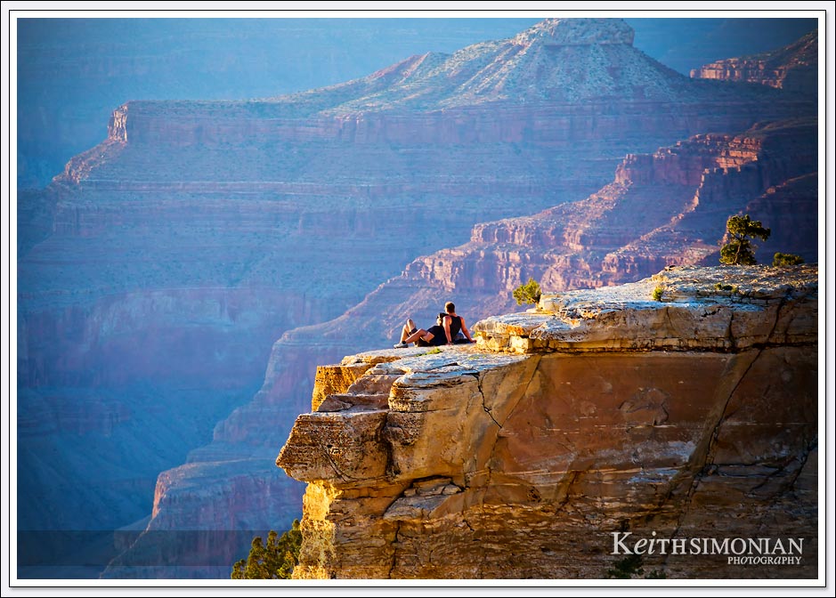 A couple watching the sunset on the South rim of the Grand Canyon from a location that I would think wasn't allowed