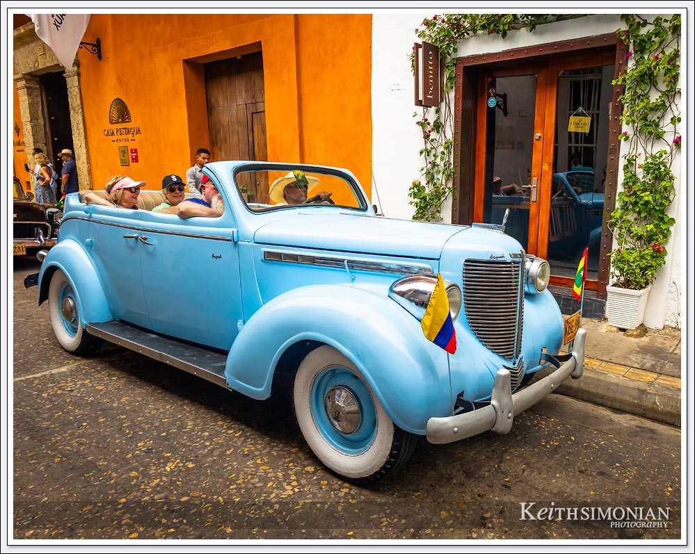 1950's classic car drives through Cartagena, Colombia.