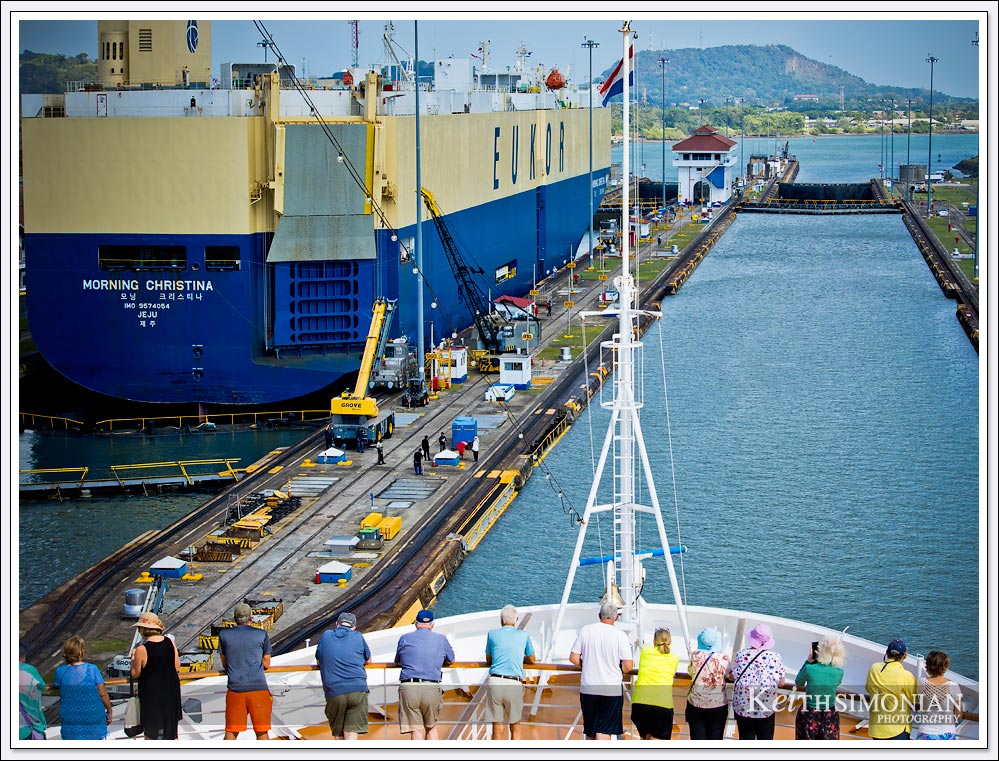 The Miraflores locks with a car carrier cargo ship passing in front of the MS Eurodam.